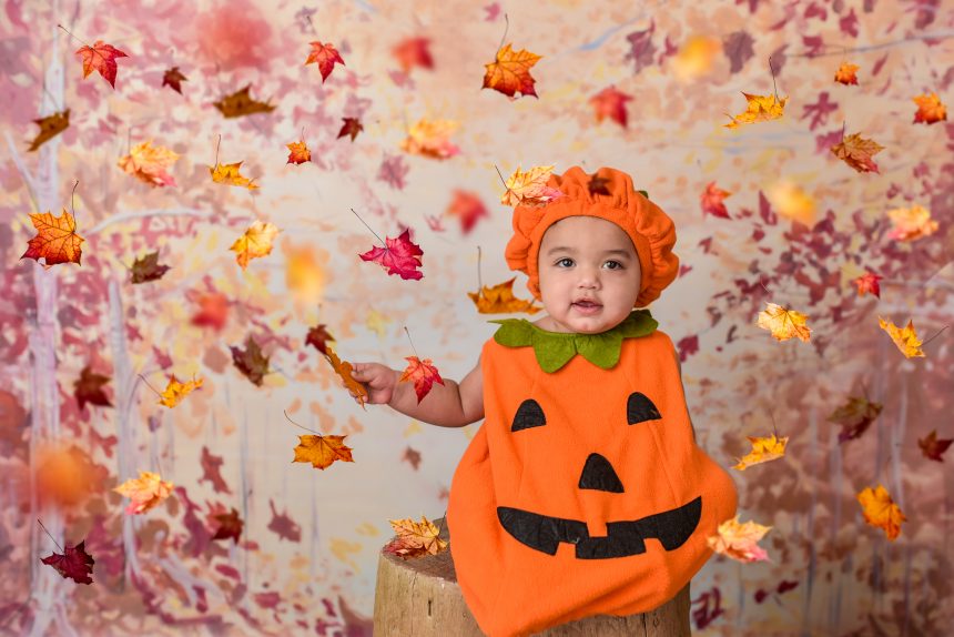 baby wearing pumkin costume