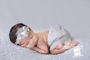 Cassandra sleeping during Christmas studio session on all-white set 