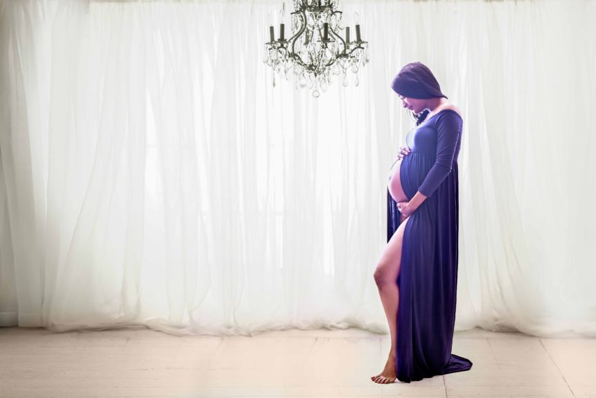 maternity session nyc photographer in front of the window