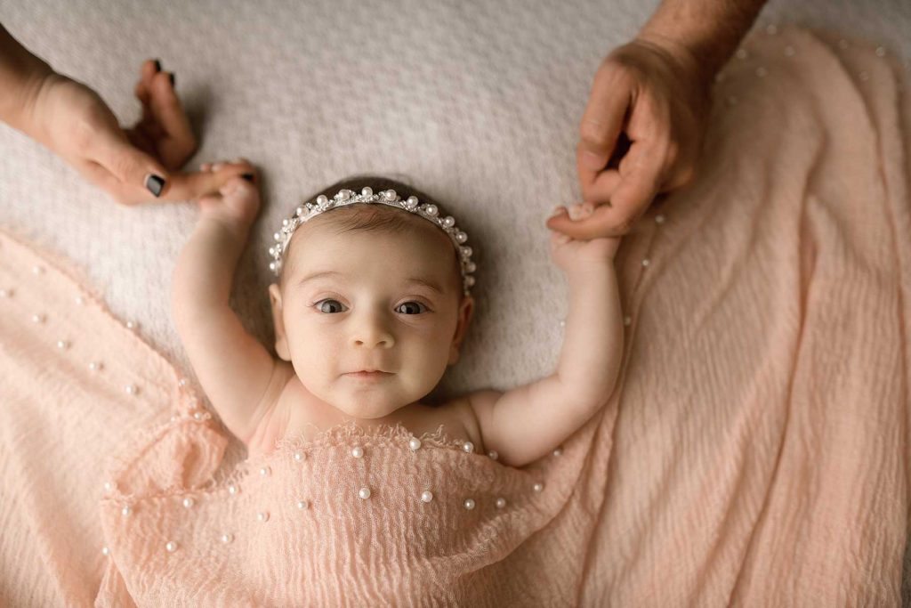 nyc baby photography parents holding newborn baby's hands