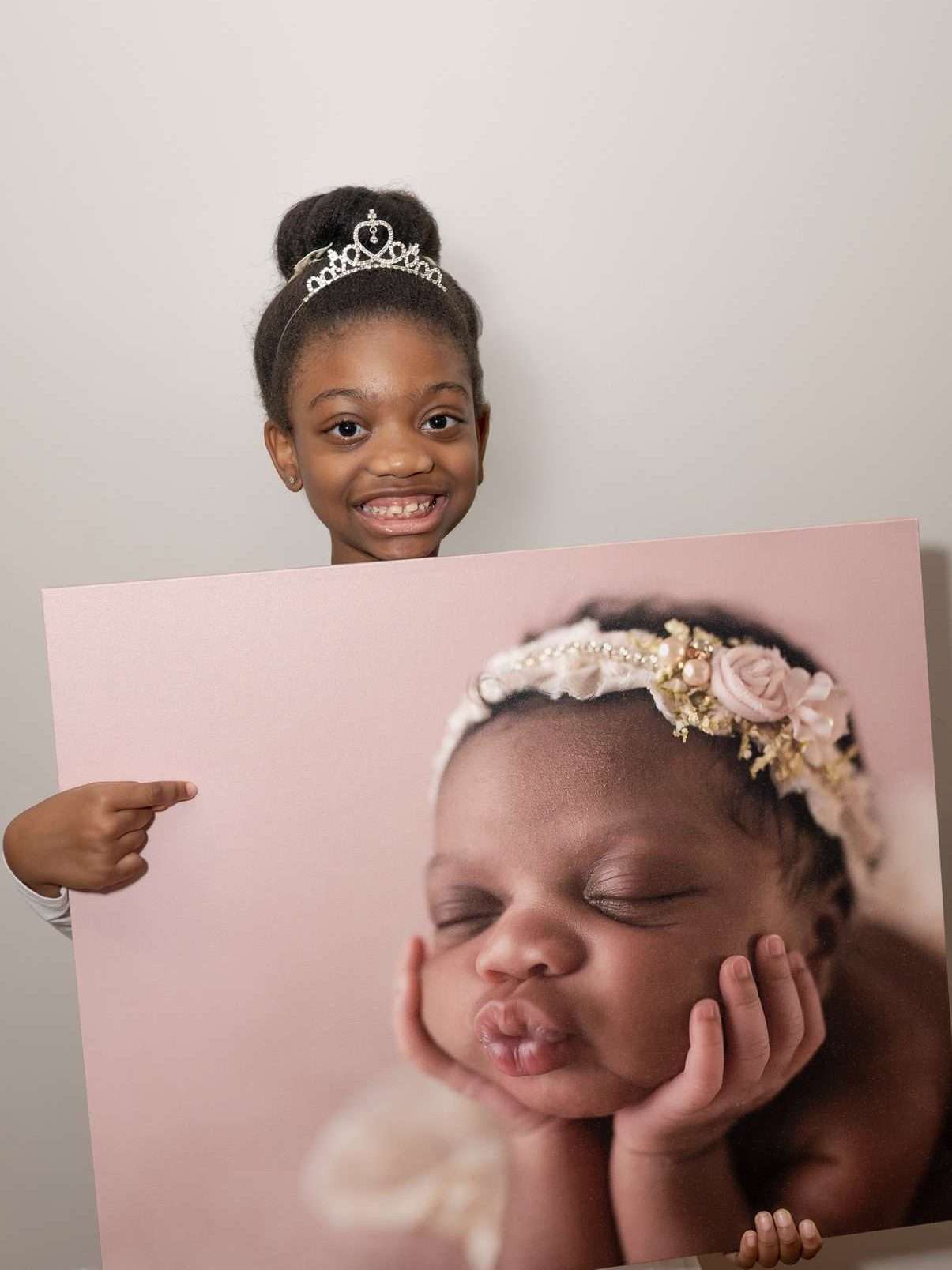 Gallery Wrap: School-Aged girl, holding a picture when she was a newborn., Baby Boy, Staten Island newborn portrait studio, newborn photoshoot NYC